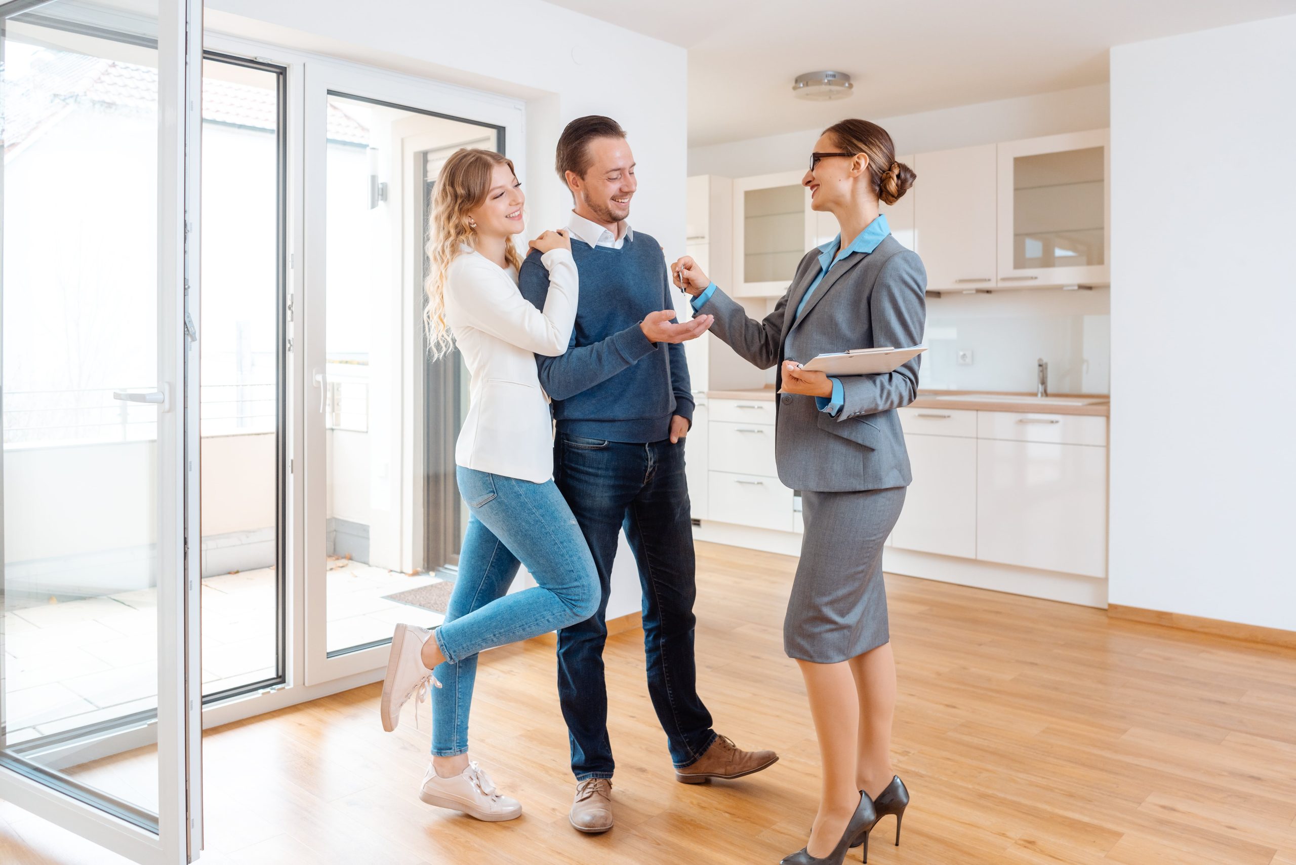 Realtor giving house key to the happy buyers or tenants